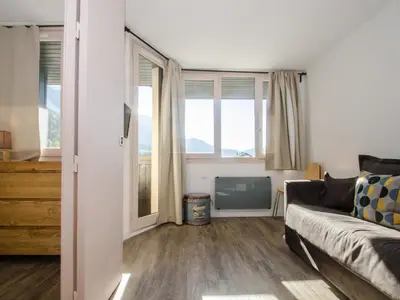 a living room with a couch and some windows at Appartement cosy à Chamonix Sud pour 4 pers, animaux acceptés - FR-1-343-157 in Chamonix-Mont-Blanc