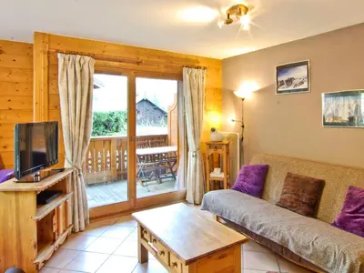 a living room with a couch and a tv at Appartement 6 pers, Chamonix, Parking - FR-1-343-169 in Chamonix-Mont-Blanc