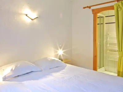 a bedroom with a white bed and a glass shower at Appartement 6 pers, Chamonix, Parking - FR-1-343-169 in Chamonix-Mont-Blanc