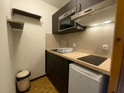 a small kitchen with a sink and a stove at Studio cosy avec Wifi au pied des pistes - 4 pers. - FR-1-343-154 in Chamonix-Mont-Blanc