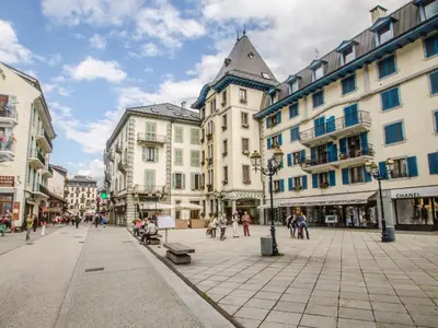 a city street with buildings and people walking around at Bel appartement 3 étoiles avec balcon au cœur de Chamonix - FR-1-343-165 in Chamonix-Mont-Blanc