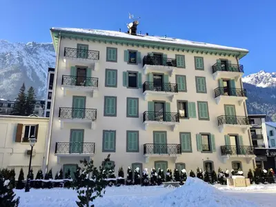 a building with snow on the ground in front of it at Bel appartement 3 étoiles avec balcon au cœur de Chamonix - FR-1-343-165 in Chamonix-Mont-Blanc