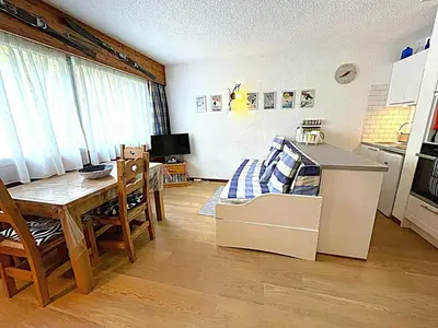 a room with a table and a kitchen with a bed at Studio au pied des pistes à Chamonix avec parking privé, proche centre - FR-1-343-162 in Chamonix-Mont-Blanc