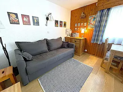 a living room with a couch and a table at Studio au pied des pistes à Chamonix avec parking privé, proche centre - FR-1-343-162 in Chamonix-Mont-Blanc
