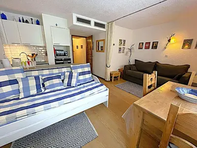 a living room with a couch and a table at Studio au pied des pistes à Chamonix avec parking privé, proche centre - FR-1-343-162 in Chamonix-Mont-Blanc