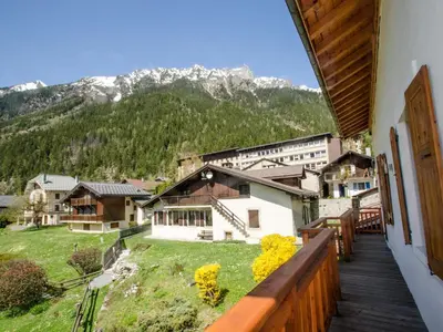 a view from a balcony of a town with mountains at Appartement spacieux à Chamonix, 3 chambres, WiFi - FR-1-343-176 in Chamonix-Mont-Blanc