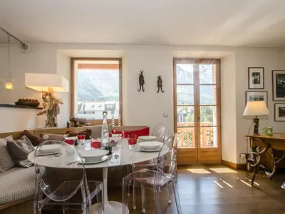 a living room with a table and a couch at Appartement spacieux à Chamonix, 3 chambres, WiFi - FR-1-343-176 in Chamonix-Mont-Blanc
