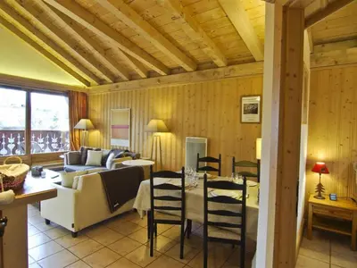a living room with a couch and a table and chairs at Bel appartement 3 étoiles avec parking et wifi, proche pistes à Chamonix - FR-1-343-168 in Chamonix-Mont-Blanc