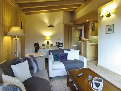 a living room with a couch and a table at Bel appartement 3 étoiles avec parking et wifi, proche pistes à Chamonix - FR-1-343-168 in Chamonix-Mont-Blanc