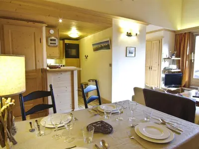 a dining room table with plates and glasses on it at Bel appartement 3 étoiles avec parking et wifi, proche pistes à Chamonix - FR-1-343-168 in Chamonix-Mont-Blanc
