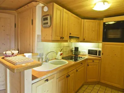 a kitchen with wooden cabinets and a sink at Bel appartement 3 étoiles avec parking et wifi, proche pistes à Chamonix - FR-1-343-168 in Chamonix-Mont-Blanc