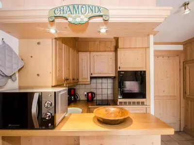 a kitchen with wooden cabinets and a bowl on a counter at Bel appartement au cœur de Chamonix, près des pistes, avec parking - FR-1-343-163 in Chamonix-Mont-Blanc