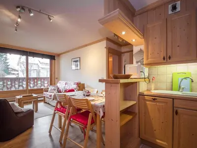a kitchen with a table and chairs in a room at Bel appartement au cœur de Chamonix, près des pistes, avec parking - FR-1-343-163 in Chamonix-Mont-Blanc