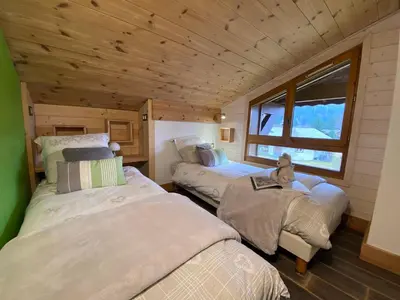 a room with two beds in a tiny house at Bel duplex à Chamonix avec poêle à bois, WiFi, parking - FR-1-343-166 in Chamonix-Mont-Blanc