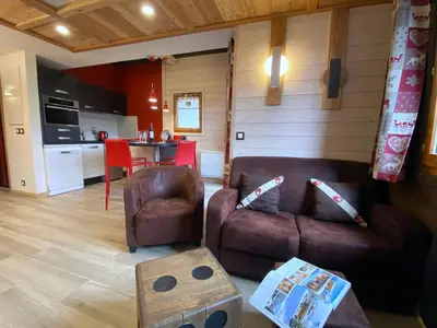 a living room with a couch and a table at Bel duplex à Chamonix avec poêle à bois, WiFi, parking - FR-1-343-166 in Chamonix-Mont-Blanc
