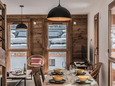 a dining room with a table and chairs at Duplex 3 étoiles pour 6 pers, Chamonix, parking privé - FR-1-343-189 in Chamonix-Mont-Blanc