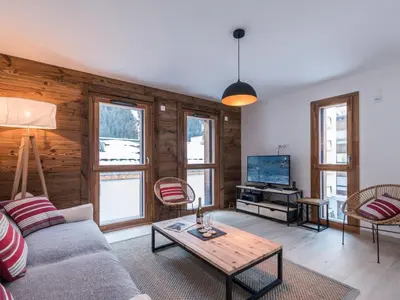 a living room with a couch and a tv at Duplex 3 étoiles pour 6 pers, Chamonix, parking privé - FR-1-343-189 in Chamonix-Mont-Blanc