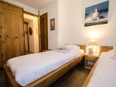 a bedroom with two beds and a lamp on a table at Appartement Chamonix, terrasse, 4 pers, parking privé - FR-1-343-172 in Chamonix-Mont-Blanc