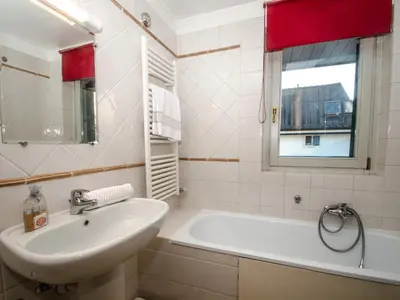 a bathroom with a sink and a tub and a window at Charmant duplex au cœur de Chamonix avec wifi et animaux admis - FR-1-343-183 in Chamonix-Mont-Blanc