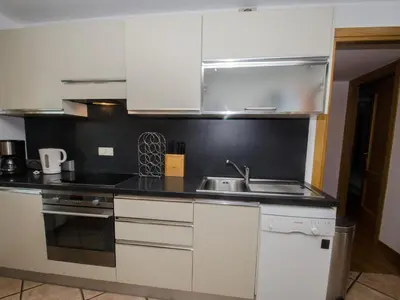 a kitchen with white cabinets and a sink at Charmant duplex au cœur de Chamonix avec wifi et animaux admis - FR-1-343-183 in Chamonix-Mont-Blanc