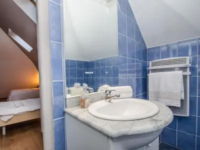 a blue tiled bathroom with a sink and a mirror at Charmant duplex au cœur de Chamonix avec wifi et animaux admis - FR-1-343-183 in Chamonix-Mont-Blanc