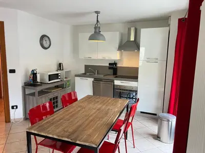 a kitchen with a wooden table and red chairs at Charmant appartement au cœur de Chamonix avec parking et animaux acceptés - FR-1-343-187 in Chamonix-Mont-Blanc