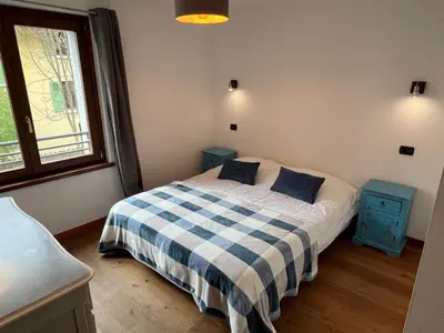 a bedroom with a bed and two blue night stands at Charmant appartement au cœur de Chamonix avec parking et animaux acceptés - FR-1-343-187 in Chamonix-Mont-Blanc