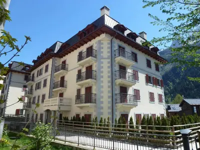 a large white building with a fence in front of it at Charmant appartement au cœur de Chamonix avec parking et animaux acceptés - FR-1-343-187 in Chamonix-Mont-Blanc