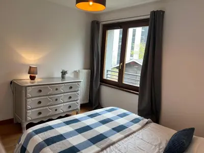 a bedroom with a bed and a dresser and a window at Charmant appartement au cœur de Chamonix avec parking et animaux acceptés - FR-1-343-187 in Chamonix-Mont-Blanc