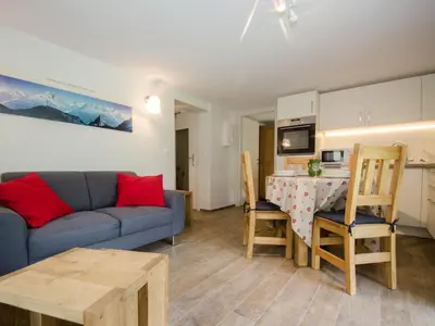 a living room with a couch and a table at Appartement rénové avec vue Mont-Blanc, parking et WiFi à Chamonix - FR-1-343-206 in Chamonix-Mont-Blanc