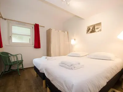 a bedroom with two beds with white sheets and a window at Appartement rénové avec vue Mont-Blanc, parking et WiFi à Chamonix - FR-1-343-206 in Chamonix-Mont-Blanc