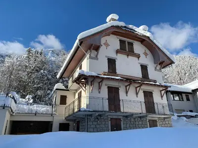 a building with snow on the ground in front of it at Appartement rénové avec vue Mont-Blanc, parking et WiFi à Chamonix - FR-1-343-206 in Chamonix-Mont-Blanc