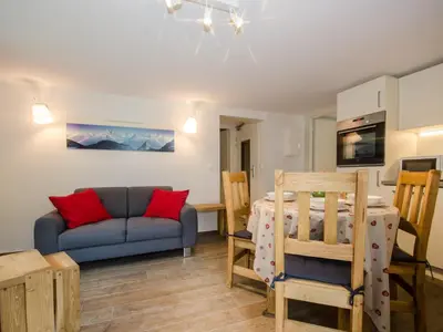 a living room with a couch and a table at Appartement rénové avec vue Mont-Blanc, parking et WiFi à Chamonix - FR-1-343-206 in Chamonix-Mont-Blanc