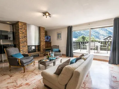 a living room with a couch and a fireplace at Appartement spacieux à Chamonix avec terrasse et parking privé - FR-1-343-173 in Chamonix-Mont-Blanc