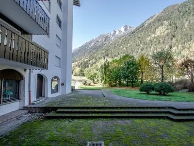 a large apartment building with a pathway in front of it at Appartement spacieux à Chamonix avec terrasse et parking privé - FR-1-343-173 in Chamonix-Mont-Blanc