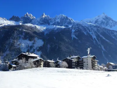 a resort in the snow with mountains in the background at Appartement spacieux à Chamonix avec terrasse et parking privé - FR-1-343-173 in Chamonix-Mont-Blanc