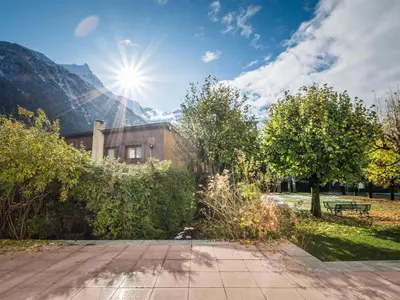 a building with the sun in the sky at Superbe 4* Appartement de 3 Chambres au Cœur de Chamonix avec Wifi - FR-1-343-186 in Chamonix-Mont-Blanc