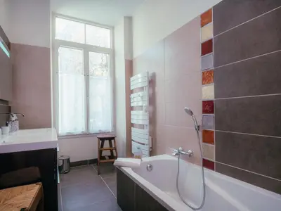 a bathroom with a bath tub and a sink at Superbe 4* Appartement de 3 Chambres au Cœur de Chamonix avec Wifi - FR-1-343-186 in Chamonix-Mont-Blanc