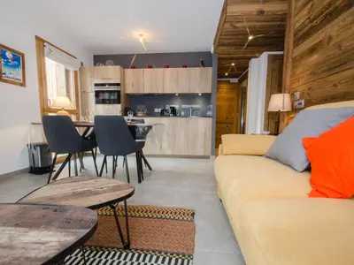 a living room with a couch and a table at Appartement chalet à Chamonix avec wifi et parking privé - FR-1-343-201 in Chamonix-Mont-Blanc