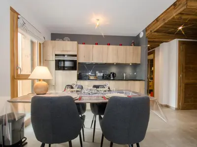 a kitchen with a table and chairs in a room at Appartement chalet à Chamonix avec wifi et parking privé - FR-1-343-201 in Chamonix-Mont-Blanc