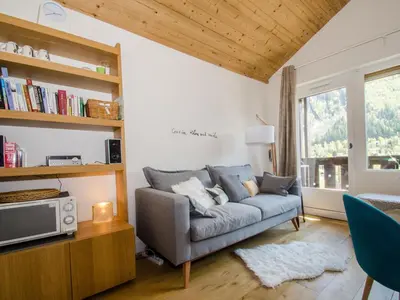 a living room with a couch and a tv at Charmant appartement à Chamonix avec parking, proche du centre - FR-1-343-203 in Chamonix-Mont-Blanc