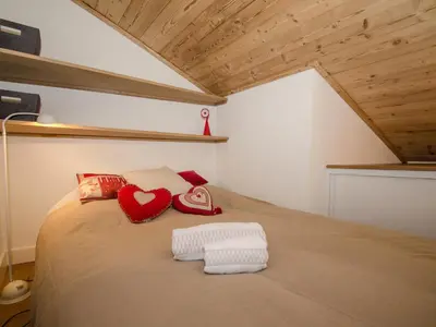 a bedroom with a bed with two hearts on it at Charmant appartement à Chamonix avec parking, proche du centre - FR-1-343-203 in Chamonix-Mont-Blanc