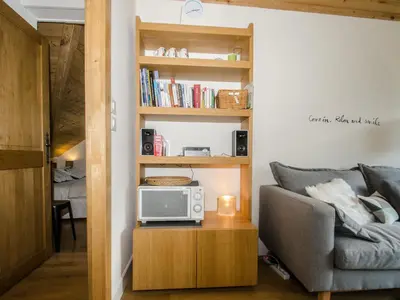 a living room with a couch and a microwave on a table at Charmant appartement à Chamonix avec parking, proche du centre - FR-1-343-203 in Chamonix-Mont-Blanc