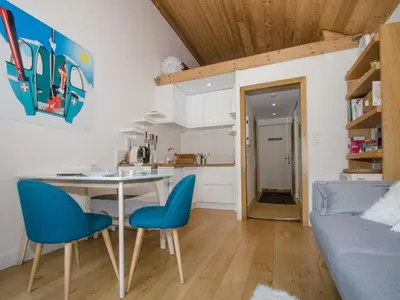a kitchen and living room with a table and chairs at Charmant appartement à Chamonix avec parking, proche du centre - FR-1-343-203 in Chamonix-Mont-Blanc