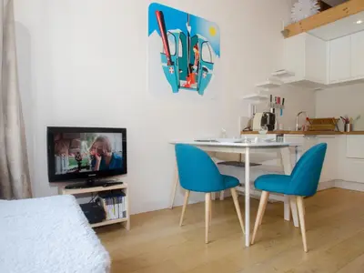 a living room with a table and chairs and a television at Charmant appartement à Chamonix avec parking, proche du centre - FR-1-343-203 in Chamonix-Mont-Blanc