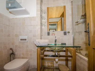 a bathroom with a sink and a toilet and a mirror at Charmant appartement à Chamonix avec parking, proche du centre - FR-1-343-203 in Chamonix-Mont-Blanc