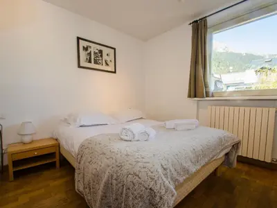 a bedroom with two beds with towels on the bed at Appartement calme en centre-ville avec terrasse et vue Mont-Blanc, Chamonix - FR-1-343-198 in Chamonix-Mont-Blanc