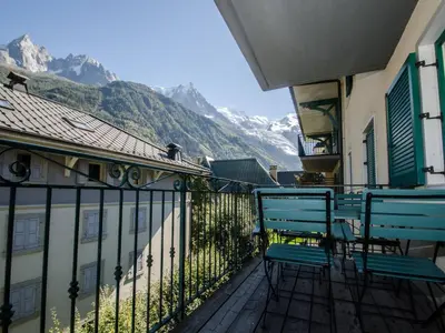 two chairs on a balcony with a view of a mountain at Appartement calme en centre-ville avec terrasse et vue Mont-Blanc, Chamonix - FR-1-343-198 in Chamonix-Mont-Blanc