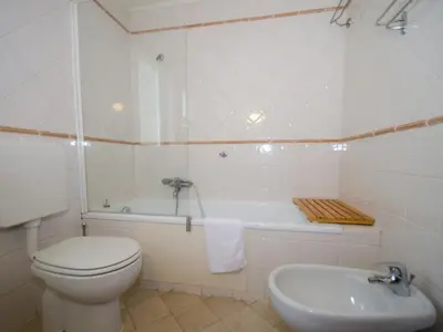 a bathroom with a toilet and a tub and a sink at Appartement calme en centre-ville avec terrasse et vue Mont-Blanc, Chamonix - FR-1-343-198 in Chamonix-Mont-Blanc
