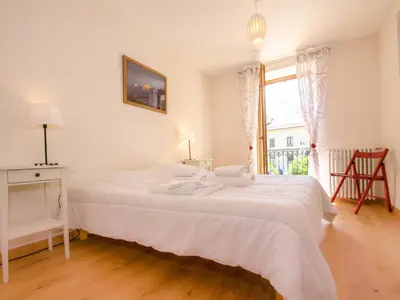 a white bed in a room with a window at Appartement central à Chamonix avec parking et wifi, proche pistes - FR-1-343-194 in Chamonix-Mont-Blanc